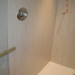 Shower panels fiitted around tray, shower valve partially fitted